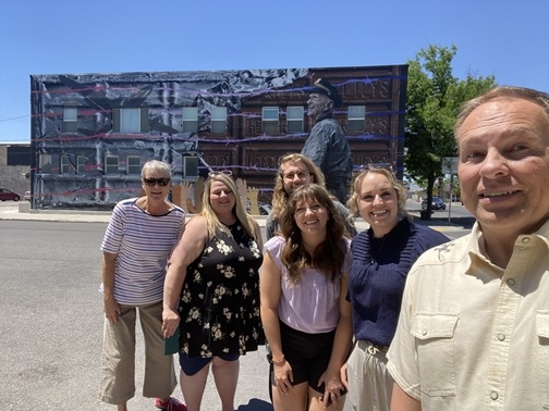 Group of people posing in front of building