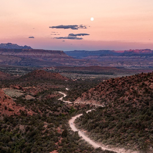 Overview forest and scenic road at sunset