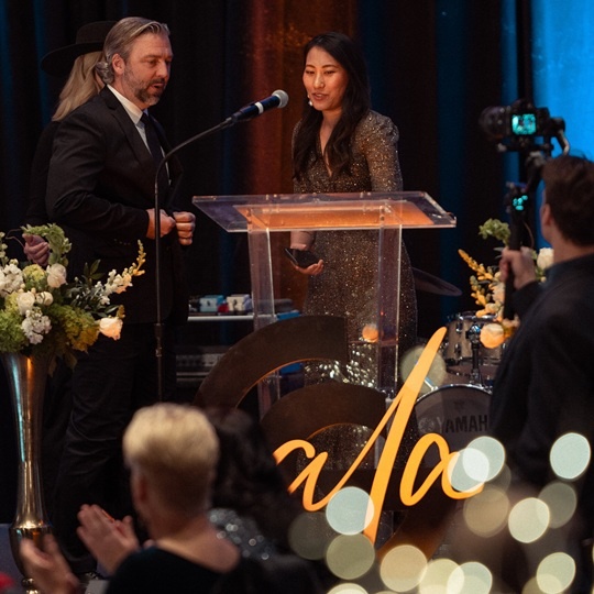 Woman presenting award to man