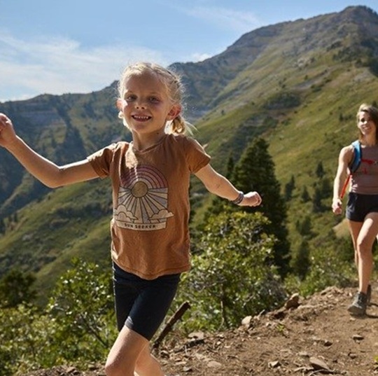Girl and mom hiking in mountains