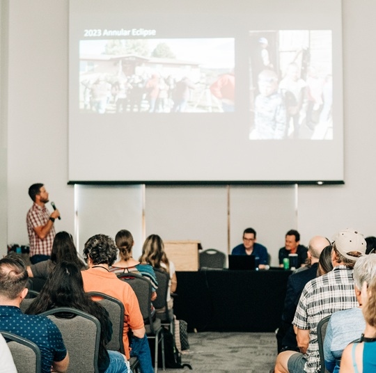 Man giving a presentation to a crowd