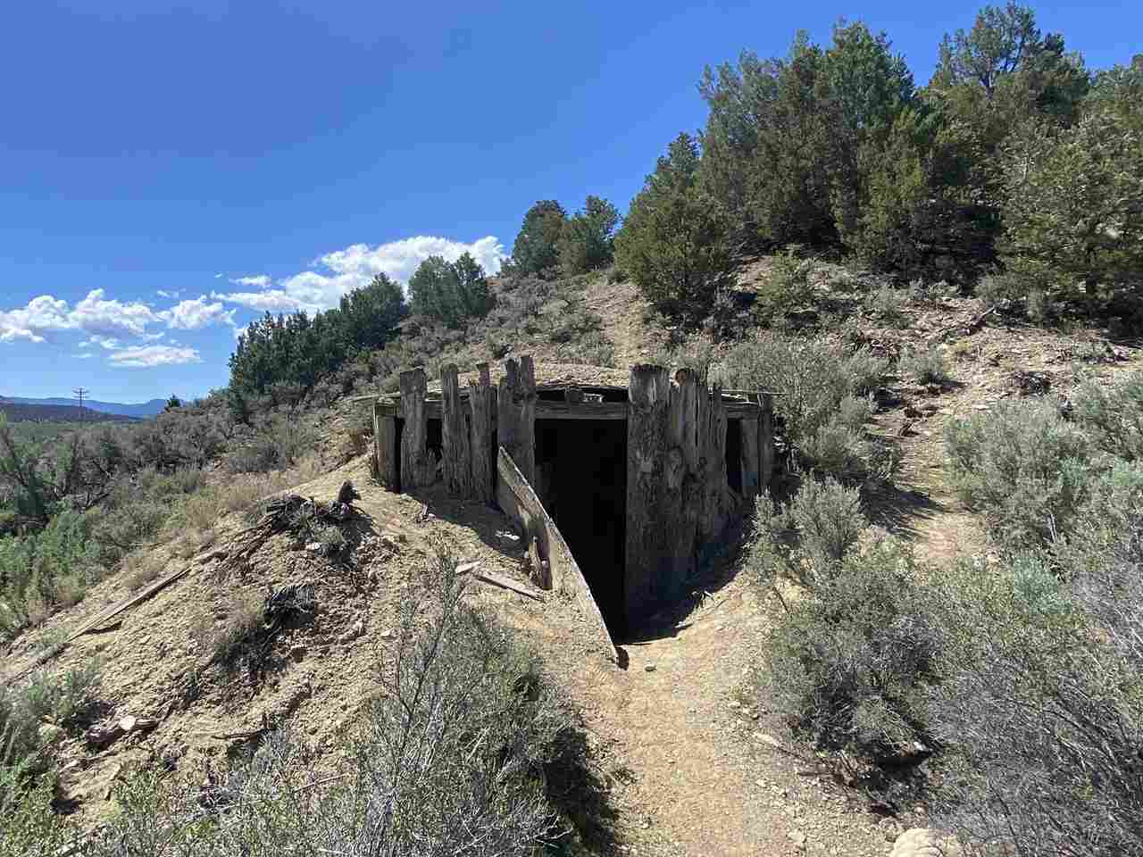 Trail leading to entryway to building built into a mountain