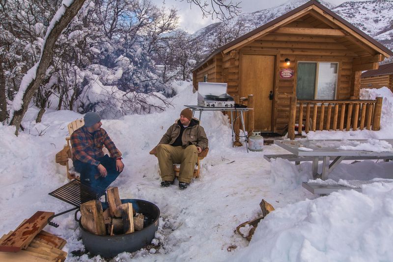 Cabin and men with fire pit n snow