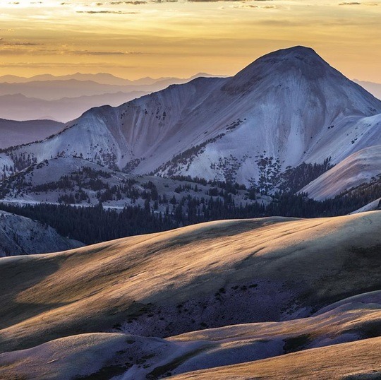 Snow on mountains at sunset