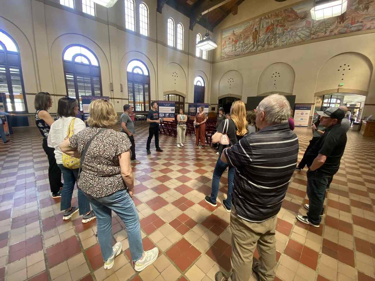 Group of people standing in circle of museum floor