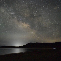 Night sky with sunset with stars over a lake