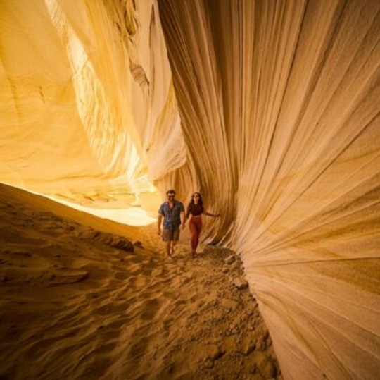 Couple hiking slot canyon